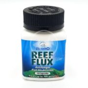 A white bottle with a black cap labeled REEF HD REEF FLUX 200 MG 10 CAPSULES sits against a blue sky and greenery backdrop. This antifungal fish medication treats up to 100 gallons effectively.