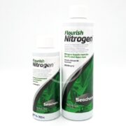 Two white bottles of SEACHEM FLOURISH NITROGEN, showcasing green leaves, stand side by side. The smaller one holds 100 mL and the larger contains 500 mL, both serving as nitrogen supplements for planted aquariums.
