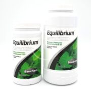 Two SEACHEM EQUILIBRIUM containers are shown: the smaller on the left and larger on the right. Both have green labels with white text, designed to restore and maintain mineral balance and GH without any sodium.