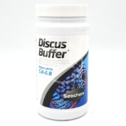A white SEACHEM DISCUS BUFFER 250 GM container, designed to adjust pH to 5.8-6.8, features a vibrant fish and blue accents on its packaging.
