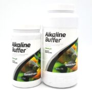 Two SEACHEM ALKALINE BUFFER containers are shown: a 300g on the left and a 600g on the right. Both have green labels with fish images and highlight their capability to effectively raise pH and alkalinity.