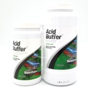 Two SEACHEM ACID BUFFER containers, one 600g (1.3 lbs) and a smaller one, show a fish image on the label. They lower pH and convert alkalinity. A code at the bottom emphasizes Seachems trusted quality.