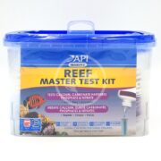 A plastic container labeled API REEF MASTER TEST KIT features a blue lid and illustrations of fish and coral. It highlights testing calcium, carbonate hardness, phosphates, and nitrates, and includes test tubes along with a color chart for precise results.