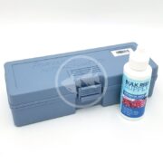 A BRS LED Refractometer setup includes a blue plastic Portable Refractometer and a white bottle of Bulk Reef Supply Refracto Juice with coral imagery, all on a white surface.