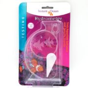 The INSTANT OCEAN HYDROMETER, crafted for aquarium salt level and specific gravity testing, features a transparent shell-like design set against a vibrant coral-themed background, combining functionality with visual appeal.