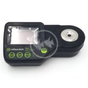 The sleek black MILWAUKEE DIGITAL REFRACTOMETER MA887 features a rectangular digital display, circular sensor area, and prominently displays the logo near the bottom. It includes green labeled buttons: READ, ZERO, RANGE, ON, and OFF.