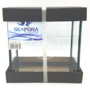 The SEAPORA 2 PLACE BETTA 1 GALLON Aquarium Tank, featuring a sleek black cardboard frame and white strap, exemplifies premium quality. Its labeled with the Seapora brand name and barcode, making it an upscale choice for discerning aquarium enthusiasts.