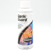 The SEACHEM GARLIC GUARD tonic additive, designed for picky eaters, comes in a white bottle featuring a vibrant fish image and branding text to enhance the taste.