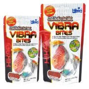The HIKARI VIBRA BITES packaging features vibrant tropical fish, emphasizing its unique formula. These worm-like bites are ideal for live food-loving fish and come in 1.23oz and 2.57oz sizes, promising to enhance pet colors splendidly.