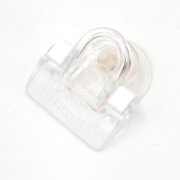 The OCEAN NUTRITION FEEDING FRENZY SEAWEED CLIP BULK is a clear rectangular plastic clip with a rounded handle and suction cup on the back, ideal for securely holding items on smooth surfaces like glass.