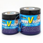 Two containers of V2O MARINE BLEND PELLET/FLAKE SINKING are shown, both black with vibrant fish labels. The larger one highlights its slow sinking nature and rich flavor, color-enhancing properties, and omega-rich nutrients.