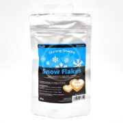 The GLAS GARTEN SHRIMP SNACKS SNOW FLAKES PUMPKIN CARROT 30 GM package features a silver foil with a blue snowflake design. It emphasizes pumpkin and carrot ingredients and has a 30g portion with an easy-to-use resealable tab at the top.