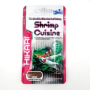 The HIKARI SHRIMP CUISINE 10 g package features vivid shrimp images and highlights its seaweed and algae benefits. Its designed for most freshwater shrimp, offering sinking food pellets to effectively nourish your aquatic pets.