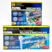Two FLUVAL BREEDING BOXES are stacked neatly; the top one labeled Breeding Box, and the bottom Multi-Chamber Holding & Breeding Box, both featuring images of water-filled boxes with small fish.
