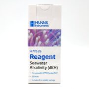 White box of HANNA MARINE ALKALINITY REAGENTS (dKH) for Seawater features 25 tests and a 1 mL plastic syringe. The packaging displays a vibrant purple and white coral image with HANNA branding at the top.