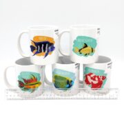 Five DECORATIVE COFFEE MUGS - CORAL REEF FISH are illustrated with Frontosa, Adonis Catfish, Cockatoo Cichlid, Emperor Angelfish, and Veiltail Betta, using a ruler for scale.