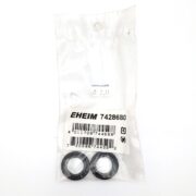 A sealed plastic package contains two circular black rubber rings labeled EHEIM 7428680 ADAPTER ORINGS 2071 - 2075. The package displays a barcode and a $7.99 price sticker, with the rings placed on a white background.