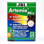 JBL ARTEMIO MIX BRINE SHRIMP EGGS AND SALT 230 GM comes with eggs and salt ready for use, featuring text in German, English, and French. The package has a green and blue design with images of brine shrimp and includes a measuring spoon.