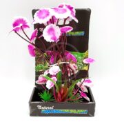 The UT FUSCIA LOVE LILY SM features pink and white fuscia blooms with a lush green base, elegantly displayed in a labeled cardboard holder. Perfect for adding charm to your aquarium.