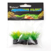 Introducing UT SPRING GRASS MINI PLANT 5 PK: A set of five natural-looking artificial aquarium plants with green and yellow tufts resembling spring grass, all on black bases. The Natural Aquarium Plant packaging displays a background of rocks and aquatic scenery for added realism.