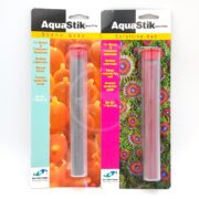 Two AQUASTIK EPOXY PUTTY 4 OZ packages sit together: the left is Stone Grey, the right Coralline Red. Both are ideal for marine and freshwater aquariums, featuring bright coral imagery on their packaging.