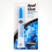 SEACHEM REEF GLUE .7 OZ is a cyanoacrylate adhesive in a sleek white tube with a blue cap on a coral-themed card. Its thicker formula ensures quick bonding, and the mess-free cap design makes it ideal for underwater use.