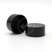 Two black cylindrical containers, resembling LEES UNDER GRAVEL FILTER CAPS, elegantly lay on a white background—one stands upright, the other gracefully rests sideways. Their glossy finish adds sophistication.