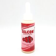 Image of SELCON 60 ML, an aquarium food booster by American Marine Inc. The bottle features a pink label with a clownfish illustration and enhances aquatic nutrition.