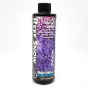 A 250 ml bottle of Brightwell Reef Snow features a sleek black design and purple coral imagery, ideal for nourishing corals and marine invertebrates.