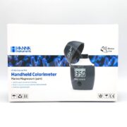 The HANNA MARINE MAGNESIUM CHECKER box highlights its accurate 1350 reading. This handheld colorimeter from Hanna Instruments is designed for aquariums and marine biology enthusiasts, featuring an open cap.