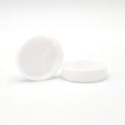 Two white, cylindrical PENN PLAX UNDER GRAVEL FILTER CAPS rest on a plain white background, one lying on its side and the other upright, with smooth surfaces gleaming softly.