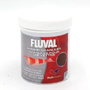 A container of Fluval Shrimp Granules with a white lid, featuring an image of a shrimp and granules on the label. The text indicates it is nutritious food for freshwater shrimp and includes multivitamins.