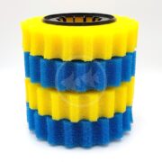 The Pondmax Filter Pad Kit is a cylindrical stack of alternating yellow and blue wavy foam layers, creating a visible pattern with flat top and bottom edges for stability. Its distinct, bold look is enhanced by the central black core.
