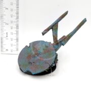 The UT RESIN SUNKEN SPACE SHIP SM ENTERPRISE, a small, colorful model with a circular front and elongated body, is shown next to a ruler for scale. It features an abstract, speckled paint design in blue, pink, and green shades.