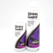 Two white bottles of Seachem StressGuard aquarium conditioner, one small and one large, with purple fish on the labels. The product is for reducing stress and healing for marine and freshwater fish.