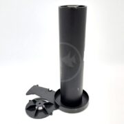 A black cylindrical plastic object stands upright with two detached round and angular components placed beside its base on a white background.