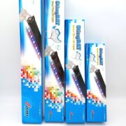 Four blue and white StingRAY aquarium LED light boxes of varying sizes are standing upright in a row, with colorful pixelated designs and fish illustrations on the packaging.