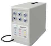 A rectangular white device labeled Smart Buddie Booster Pump with six hose connectors on the front panel, a black power cord on the left, and indicator labels for IN, OUT, FLOW, FROM, and SUPPLY.