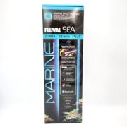 A tall blue and black box for the Fluval Sea Marine Spectrum LED aquarium light, showing product specs: 25,000K, 22 watts, fits 15–24 tanks, Bluetooth-enabled, and compatible with the Fluval Smart App.