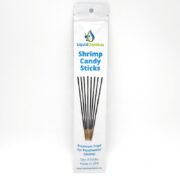 A white package labeled Liquid Gardens Shrimp Candy Sticks containing eight thin black sticks, described as premium food for freshwater shrimp. The text notes the sticks are made in the USA.