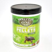 A container of Omega One Juvenile Turtle Pellets with a black lid, green label, and an image of a turtle. The label highlights that the pellets are floating, meal-free, and made with whole seafood.