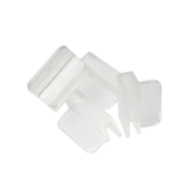 Four clear plastic corner brackets with slots and flat surfaces, arranged in a scattered manner on a white background.