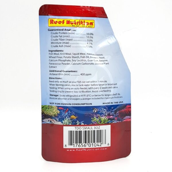 Back view of a Reef Nutrition product package for aquarium fish food, showing ingredients, guaranteed analysis, feeding directions, barcode, and colorful aquatic graphics at the bottom.