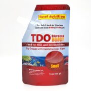 A red and silver pouch of TDO Chroma BOOST fish food by Reef Nutrition, labeled for small fish and invertebrates, with images of coral and text highlighting Haematococcus algae content.