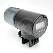 A black automatic aquarium fish feeder with a digital display, buttons for control, and a clamp for attaching to a tank. The device has a transparent food container and is shown against a white background.