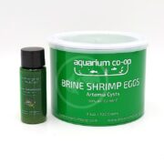 A small green bottle and a larger green tub labeled aquarium co-op Brine Shrimp Eggs Artemia Cysts 90% Hatch Rate are displayed side by side on a white background.
