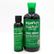 Two bottles of Aquarium Co-Op Easy Green All-in-One Fertilizer, one small and one large, both with green labels and caps, designed for planted aquariums.