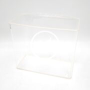 A clear, rectangular plastic container with a lid, featuring a faint circular design on the front, is placed against a plain white background.