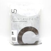A sealed 2-liter bag of Controbase aquarium substrate supplement by UN Systems, with black and white minimalist packaging and a large letter C on the front.