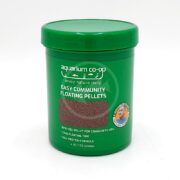 A green container labeled aquarium co-op Easy Community Floating Pellets for fish, 4 oz (13 grams). The label highlights bite-size pellets, long floating time, and a high protein formula.